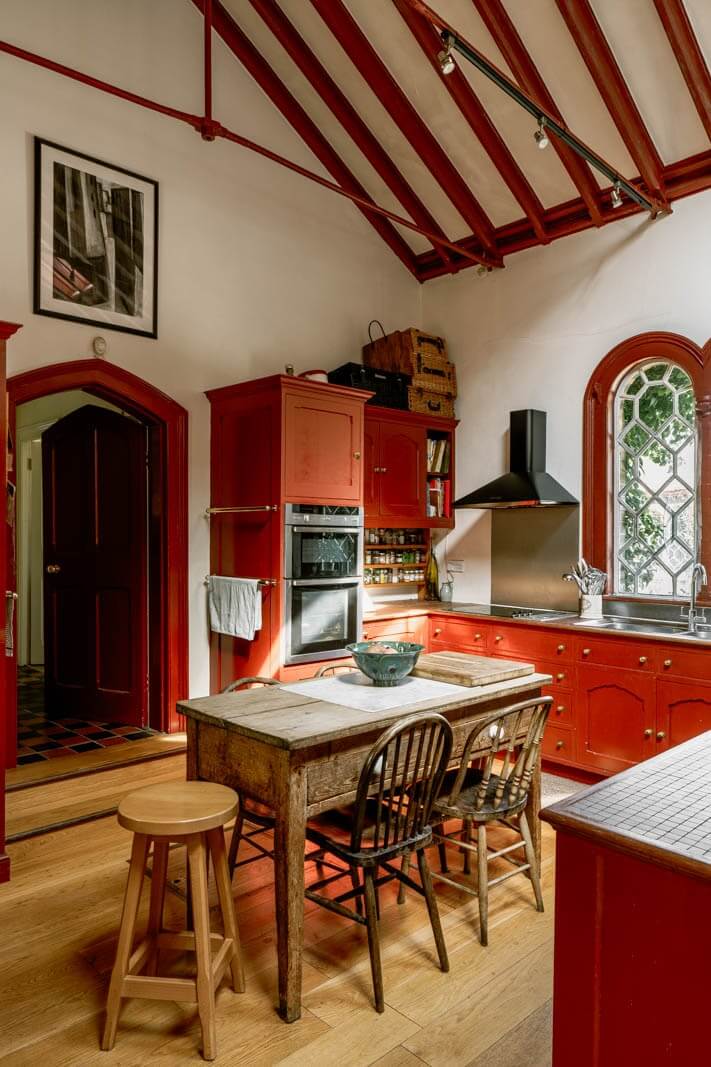Colorful Kitchen Designs That Brighten Up Your Home 37 kitchen with red cabinets and farmhouse table nordroom