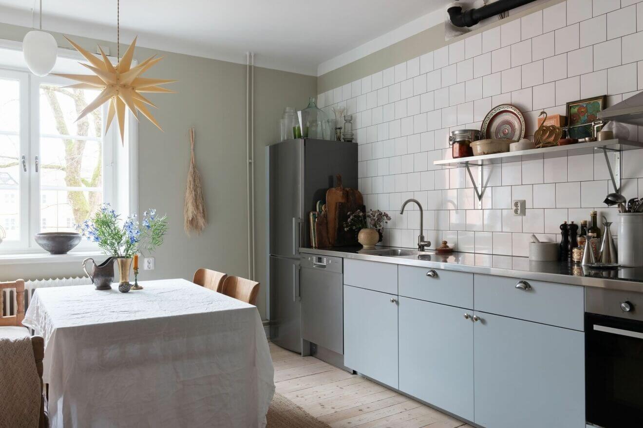 A Stockholm Apartment with Bohemian and Natural Touches 6 blue kitchen A Stockholm Apartment with Bohemian and Natural Touches