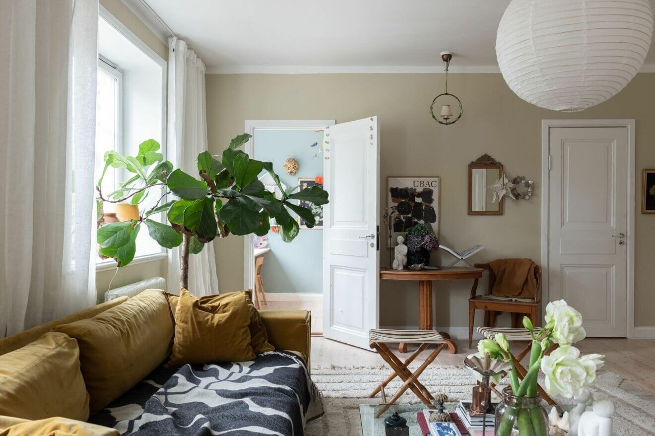 A Stockholm Apartment with Bohemian and Natural Touches 4 ochre sofa A Stockholm Apartment with Bohemian and Natural Touches