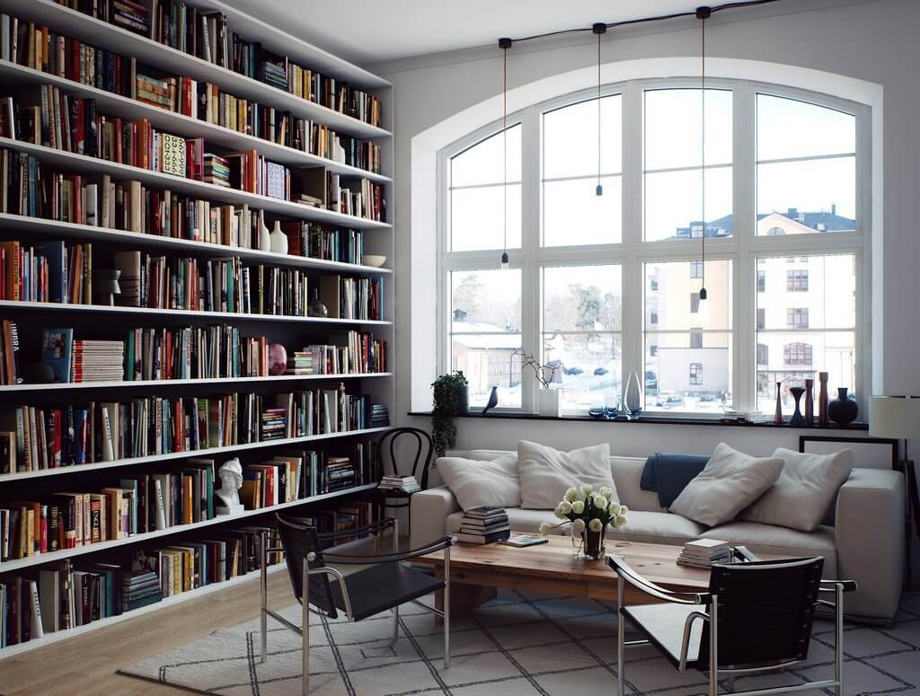 36 Home Library Ideas That Are A Book-Lover's Dream 19 scandinavian-living-room-arched-window-floor-to-ceiling-bookshelves