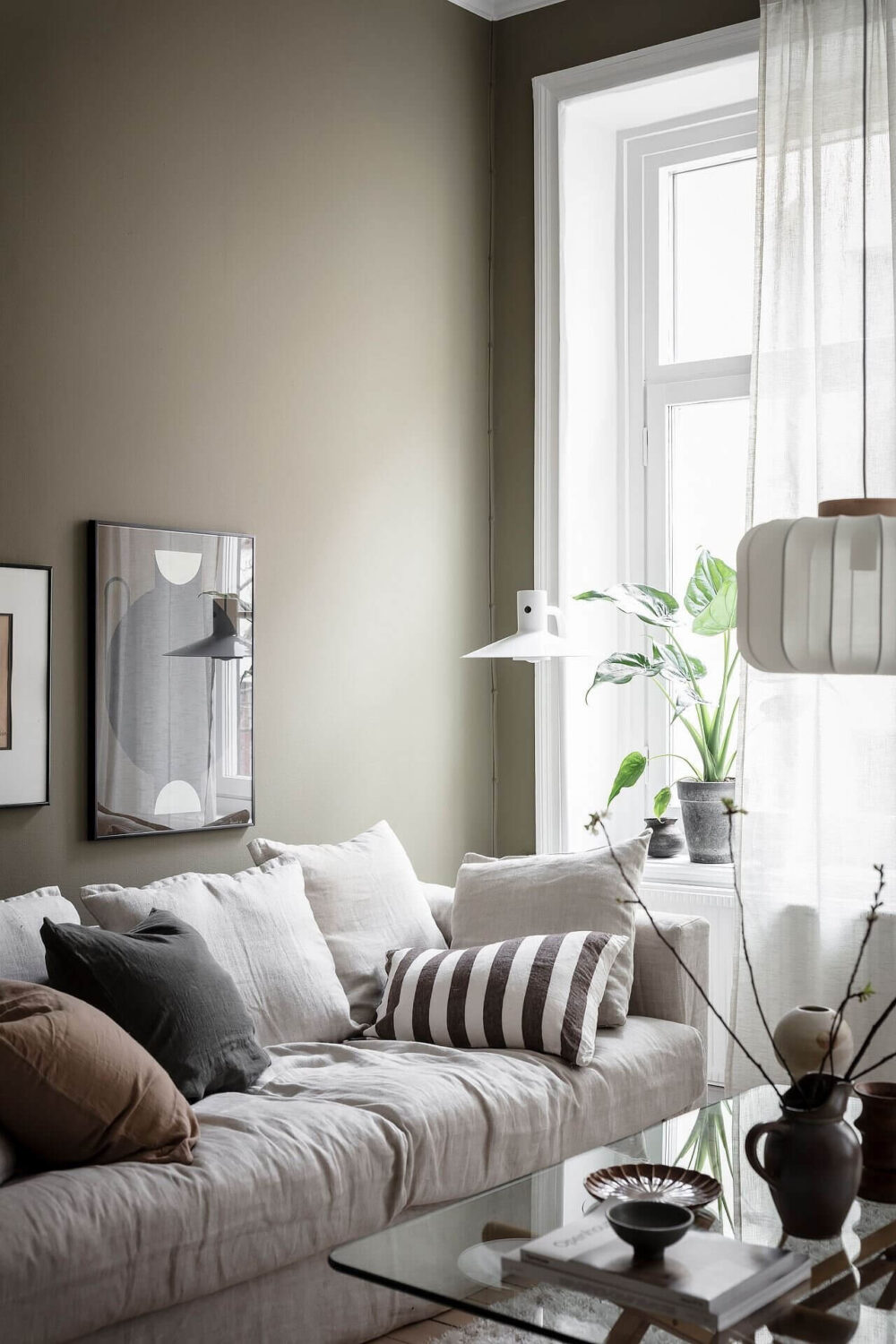 The Best Classic Paint Colors For A Timeless Living Room 25 AScandinavianApartmentWithOliveGreenWalls TheNordroom5 The Best Classic Paint Colors For A Timeless Living Room