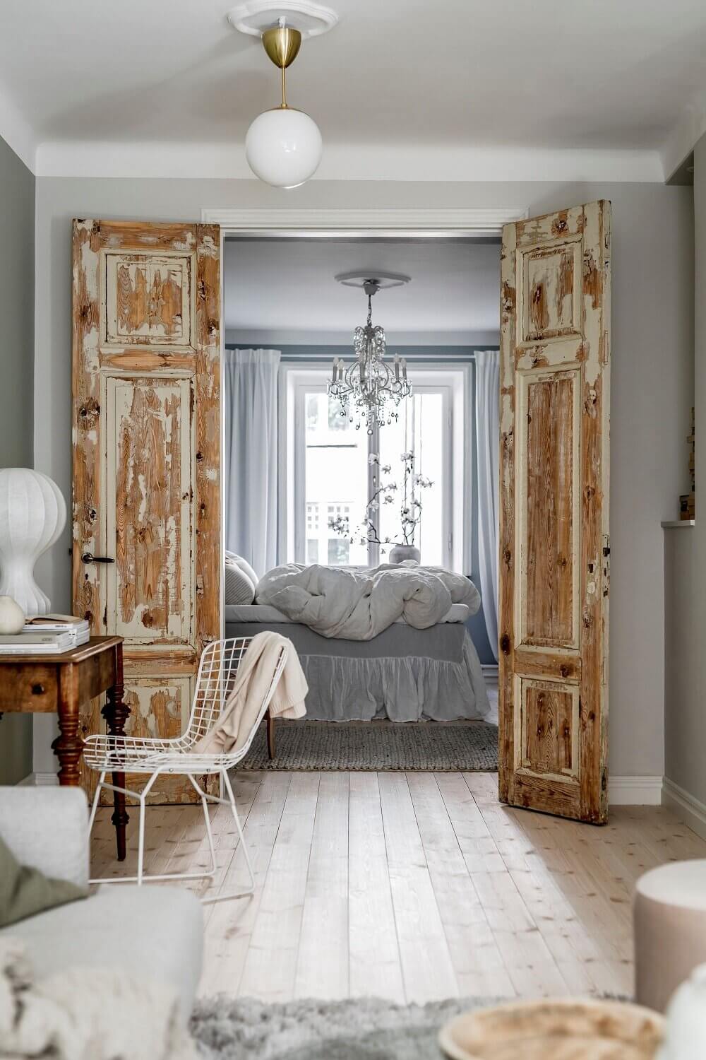 Natural Color Tones in a Charming Scandinavian Apartment 16 rustic-wooden-doors-bedroom