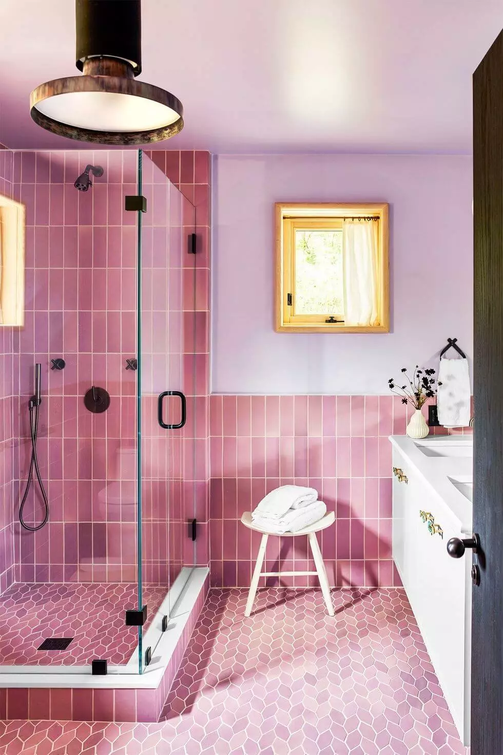 89 Pink Bathroom Ideas: From Hot Pink Walls to Blush Tiles 82 small-pink-bathroom-vertical-tiles-pendant-light-nordroom