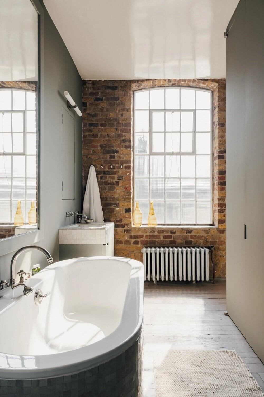 A London Loft Designed By Ilse Crawford And Vincent van Duysen 18 london-loft-ilse-crawford-vincent-van-duysen-grey-bookshelves-kitchen-island--zellige-tiles-brick-wall-victorian-warehouse-conversion-nordroom