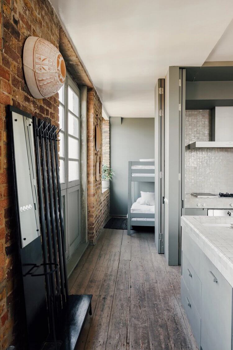 A London Loft Designed By Ilse Crawford And Vincent van Duysen 9 london-loft-ilse-crawford-vincent-van-duysen-grey-bookshelves-kitchen-island--zellige-tiles-brick-wall-victorian-warehouse-conversion-nordroom