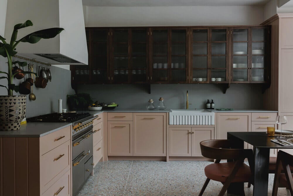 Warm Colors and Texture In A North London Family Home 3 pink-kitchen-ribbed-glass-cabinets-terrazzo-floor-london-studio-duggan-nordroom