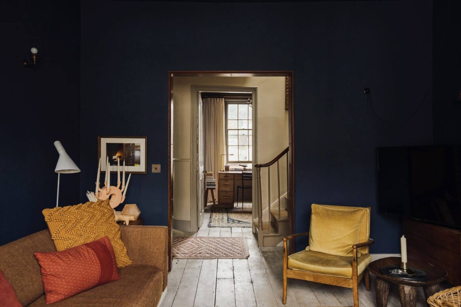Moody Colors in a Unique Historic Apartment 3 moody blue sitting room mustard yellow sofa historic apartment nordroom Moody Colors in a Unique Historic Apartment