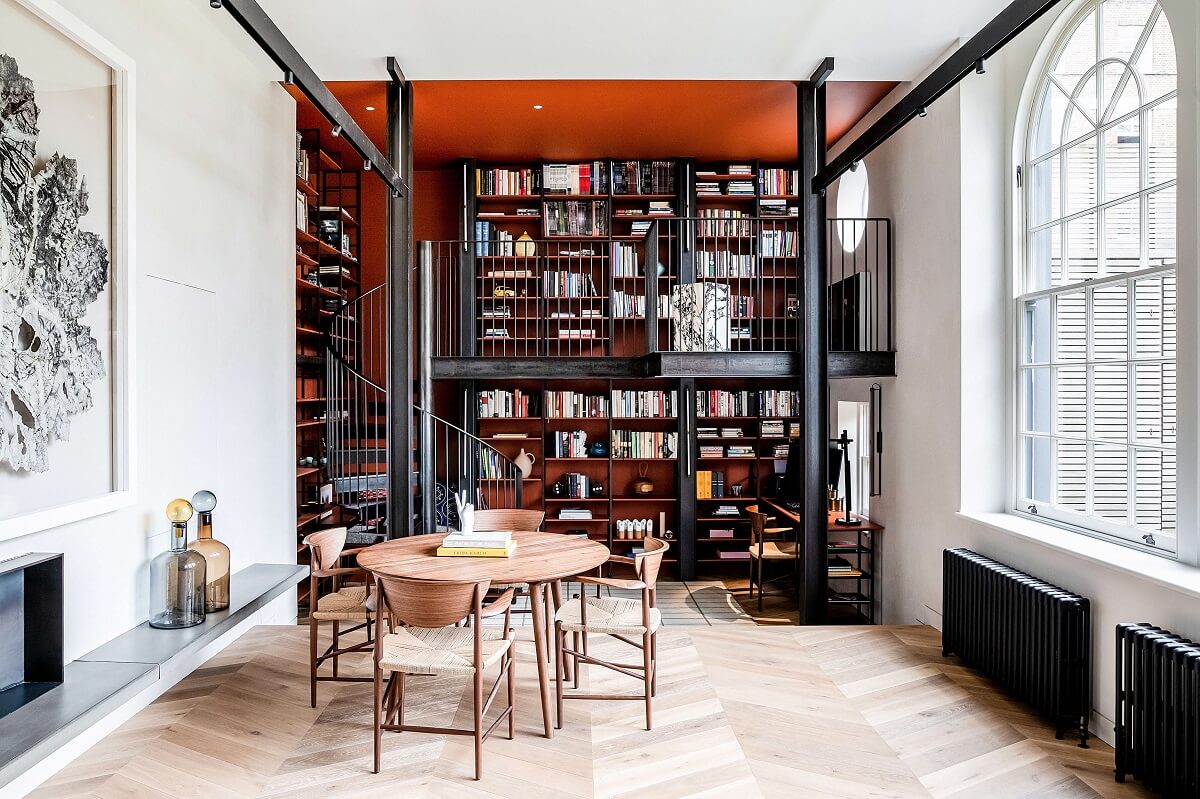 double-height-living-bookshelves-red-wall-arched-windows-mews-house-nordroom