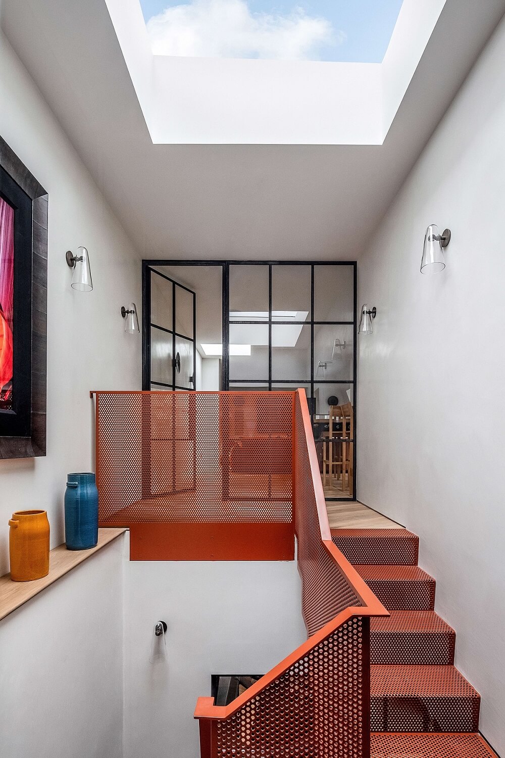A Modern Playful Mews House in London 7 red-staircase-skylight-nordroom