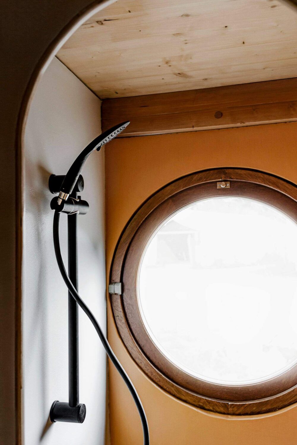 Curved Lines in a Wooden Tiny House 12 tiny-bathroom-round-window-tiny-home-nordroom