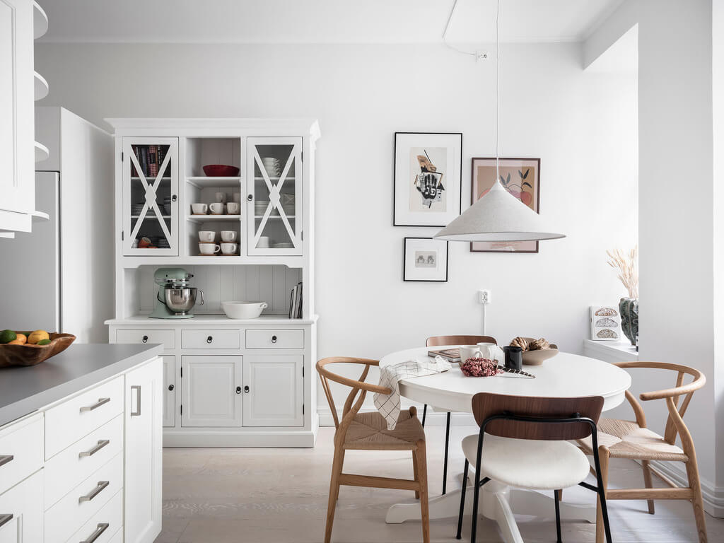 A Black Dining Room in a Stylish Apartment 15 white-kitchen-round-dining-table-nordroom