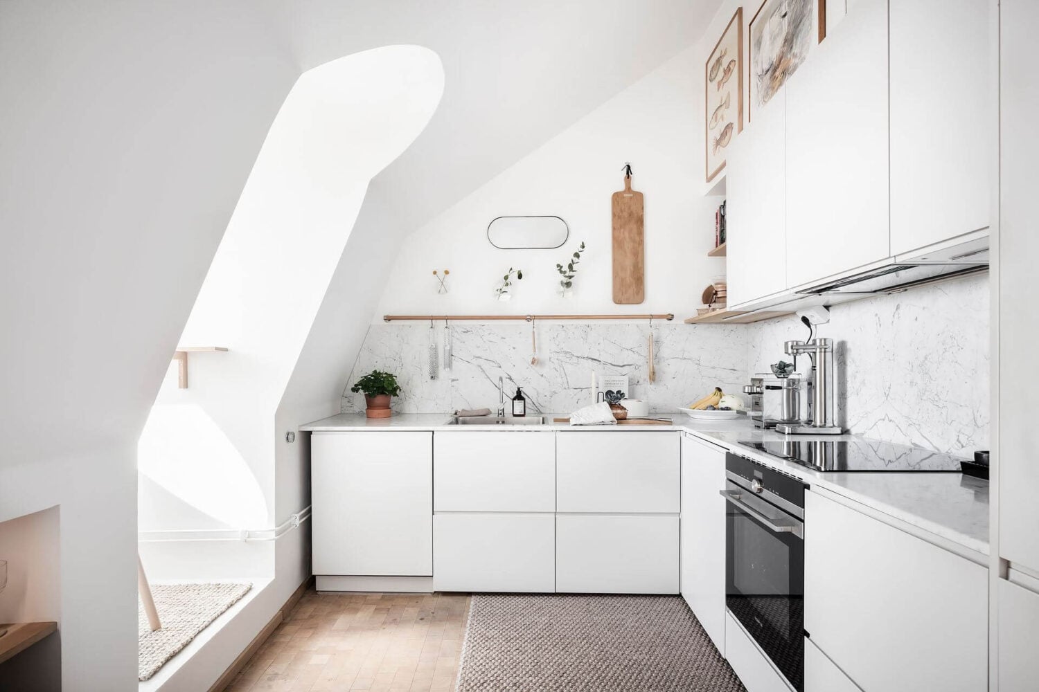 Window Seats & Creative Ideas in a Light Attic Apartment 8 white-kitchen-window-seat-slanted-ceilings-nordroom
