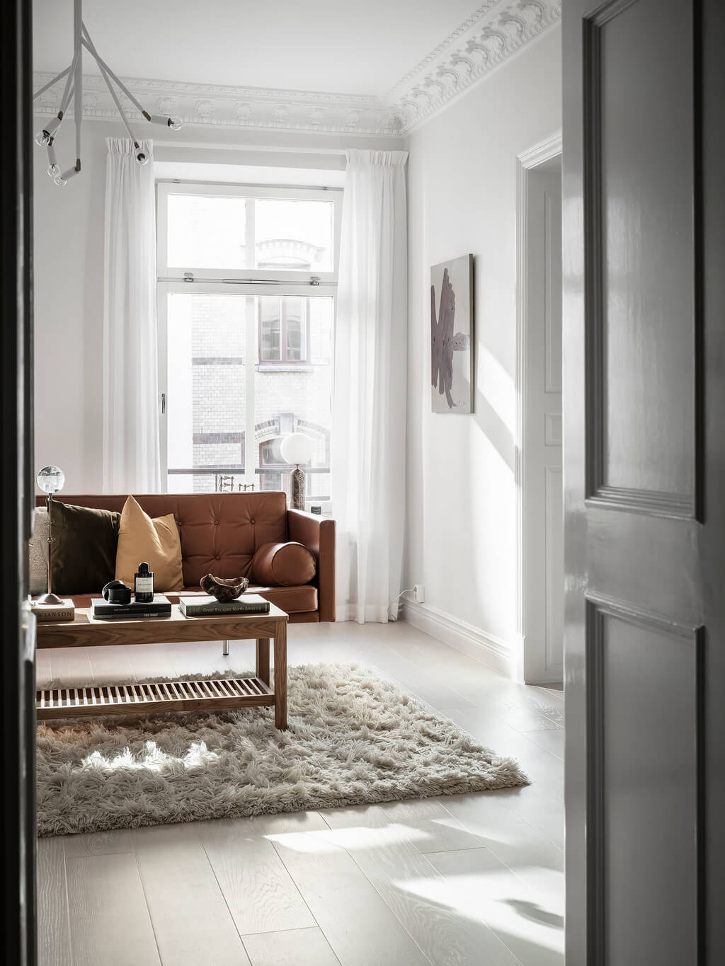 A Black Dining Room in a Stylish Apartment 7 white-living-room-tan-leather-sofa-nordroom
