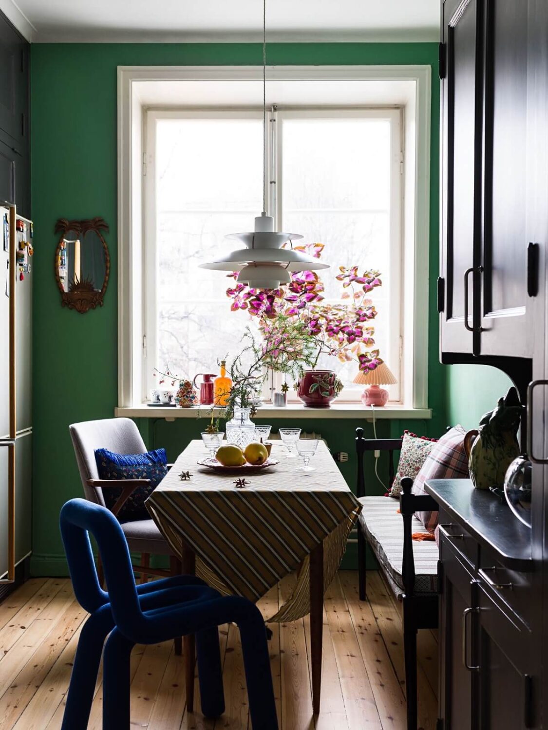 A Vibrant Colorful Scandinavian Apartment 12 green-kitchen-walls-dining-nook-nordroom