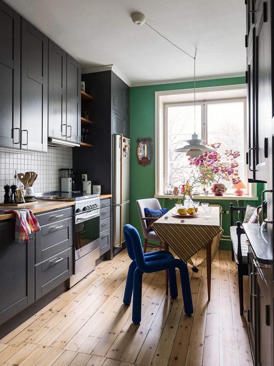 A Vibrant Colorful Scandinavian Apartment 10 grey-kitchen-cabinets-green-walls-nordroom