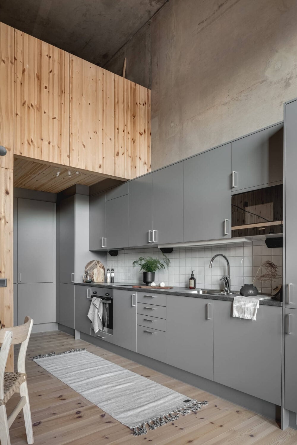 A Scandinavian Loft Made of Concrete and Wood 8 grey-loft-kitchen-scandinavian-design-nordroom
