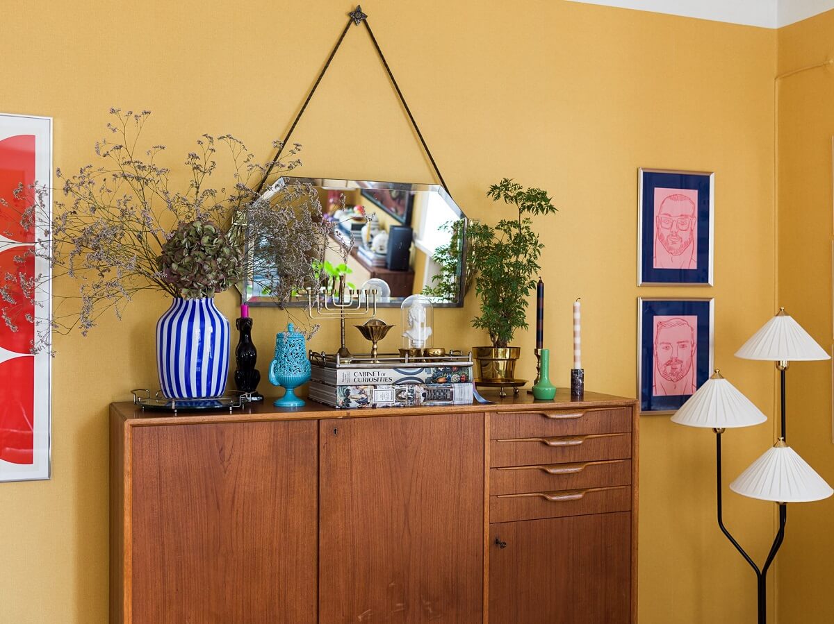 A Vibrant Colorful Scandinavian Apartment 8 midcentury-cabinet-yellow-living-room-nordroom