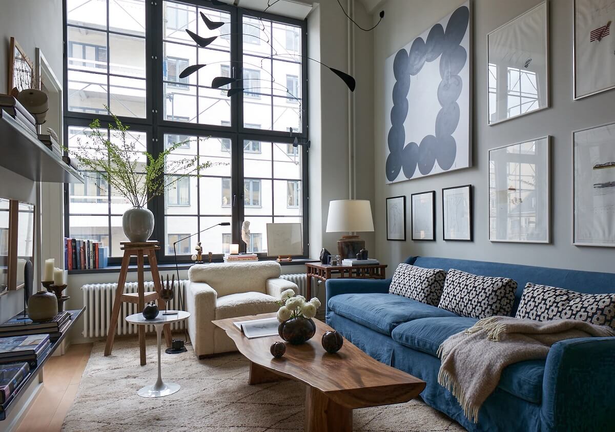 An Art-Filled Apartment in Stockholm 1 art-filled-living-room-high-ceilings-blue-sofa-nordroom