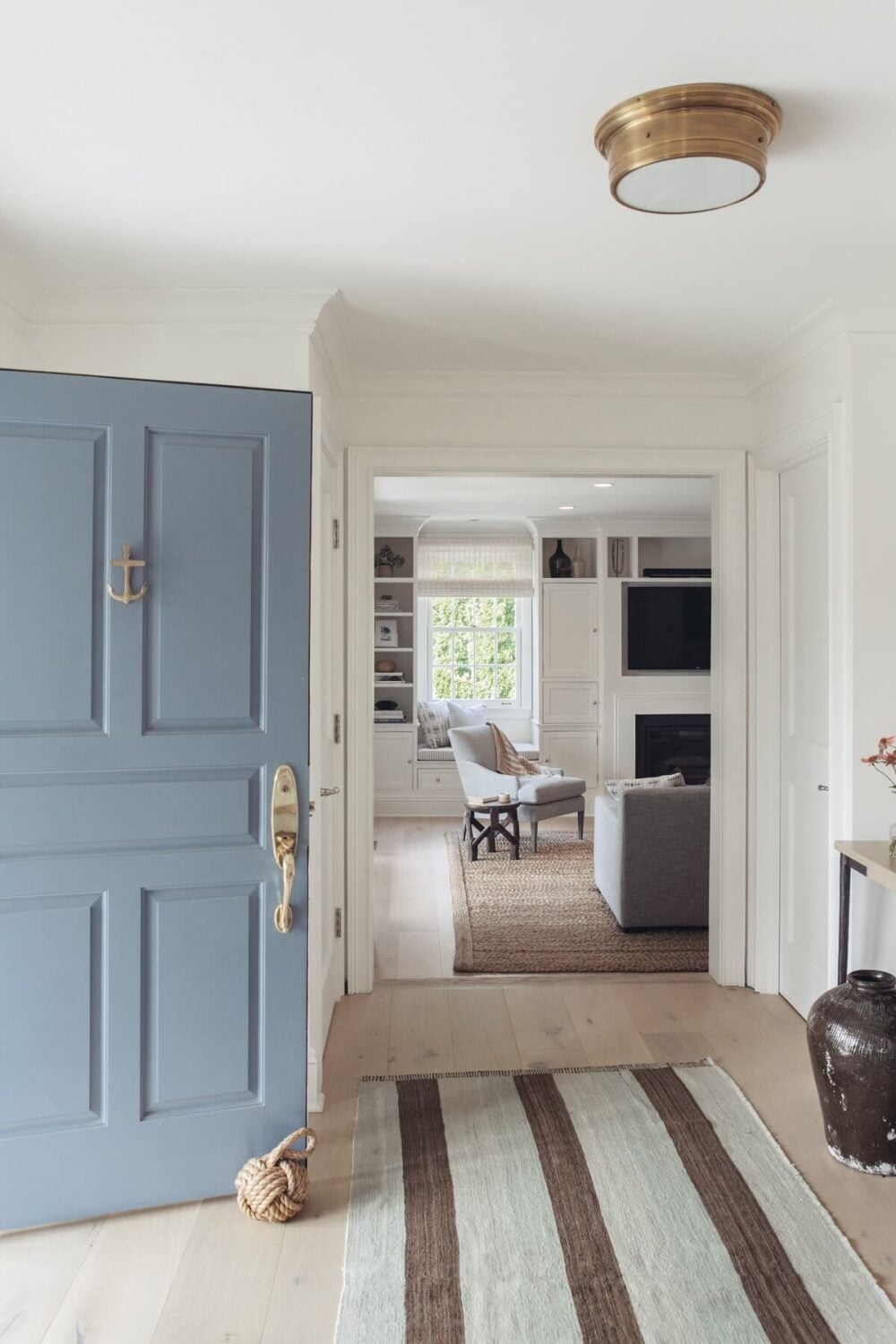 A Serene Colonial Home in Connecticut 13 hallway-striped-rug-light-blue-door-nordroom