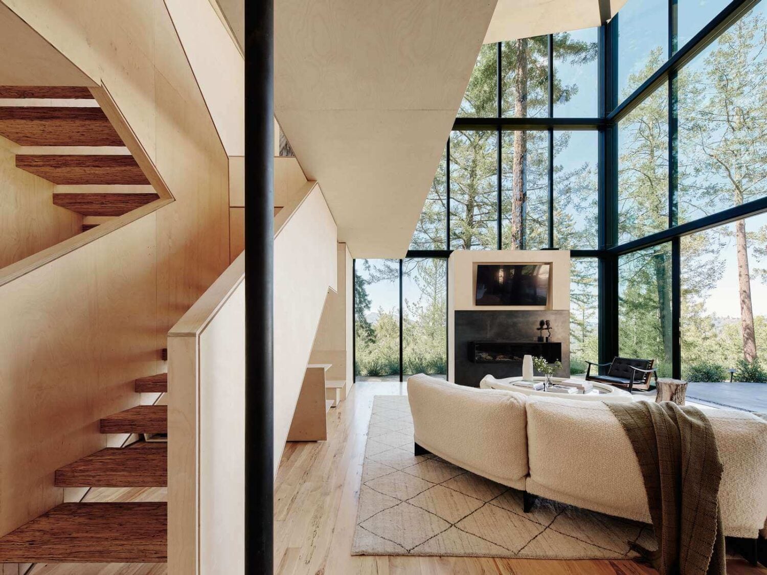 A Modern Mountaintop Home in Napa Valley 3 light-colored-living-room-curved-sofa-floor-to-ceiling-windows-nordroom