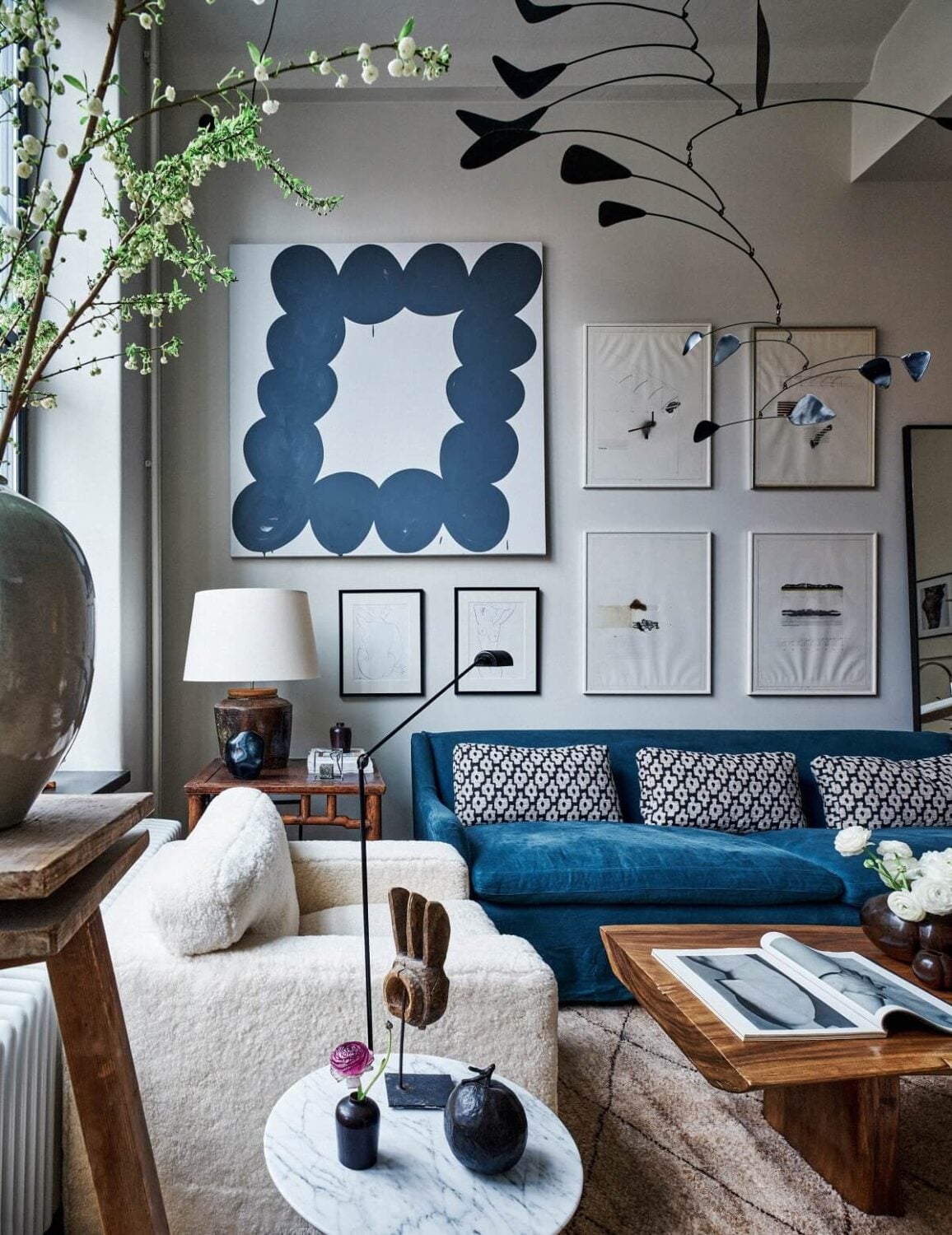 An Art-Filled Apartment in Stockholm 2 living-room-high-ceilings-art-blue-sofa-scandinavian-design-nordroom