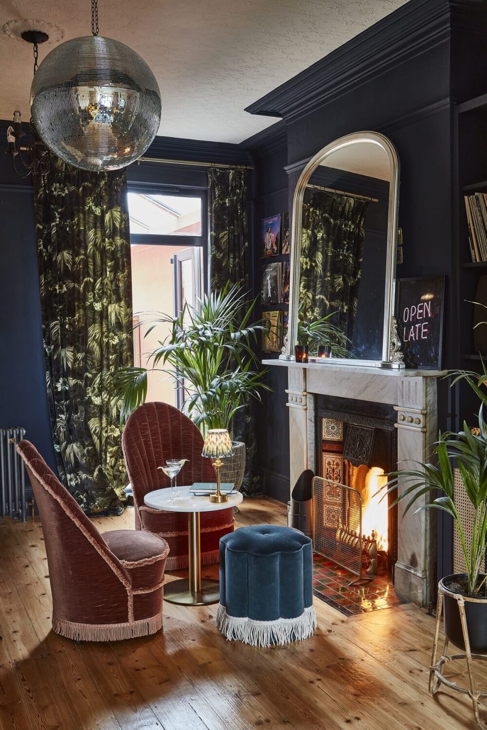 A Colorful 70s Inspired Home in London 17 moody-blue-sitting-room-velvet-chairs-fireplace-nordroom