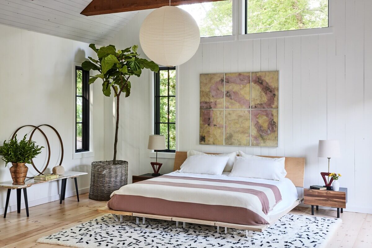 A Montauk Airbnb Designed by Robert McKinley 8 white-contemporary-bedroom-large-art-exposed-beams-nordroom