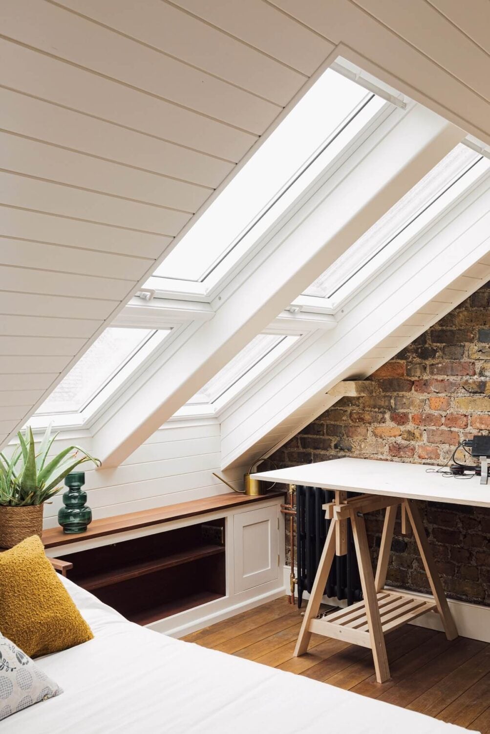 An Elegant & Colorful London House 22 attic-bedroom-slanted-ceilings-brick-wall-desk-nordroom