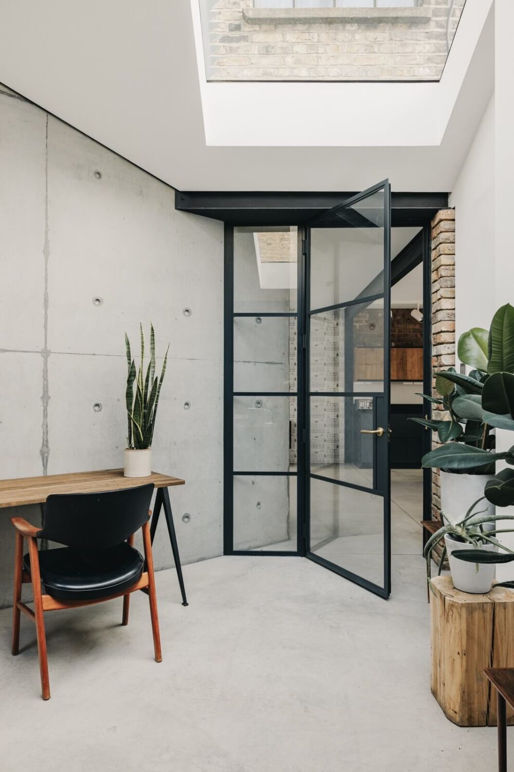 An Industrial Warehouse Conversion in London 15 home-office-skylight-industrial-doors-concrete-nordroom