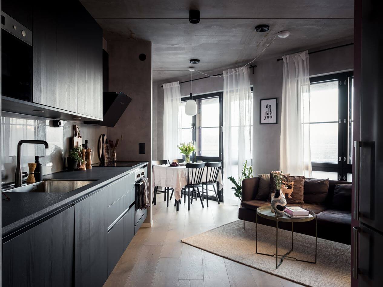 A Small Industrial Apartment with Pink Walls 1 living-room-black-kitchen-concrete-walls-nordroom