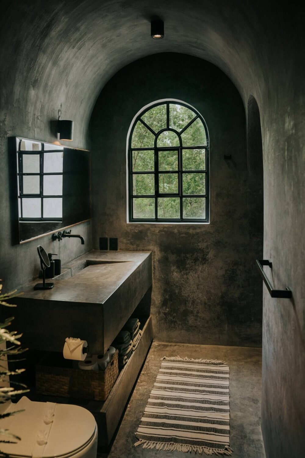 A Tulum Airbnb in an Architectural Building 23 moody-natural-bathroom-arched-window-nordroom