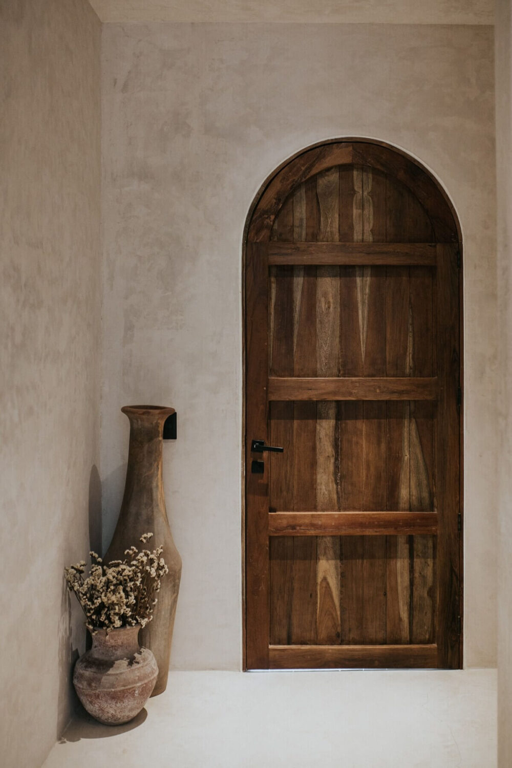 A Tulum Airbnb in an Architectural Building 16 rustic-arched-wooden-door-tulum-airbnb-nordroom
