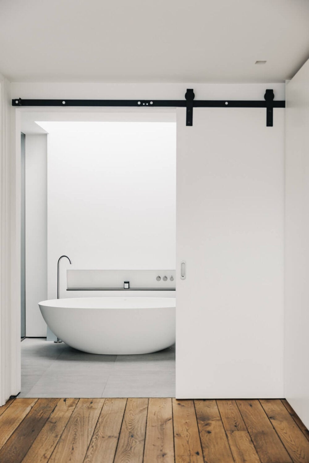 An Industrial Warehouse Conversion in London 21 white-bathroom-sliding-barn-door-industrial-warehouse-conversion-nordroom