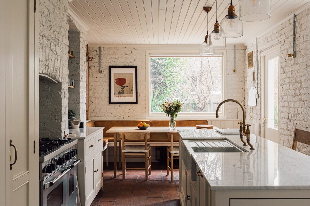 An Elegant & Colorful London House 6 white-kitchen-stone-floor-breakfast-nook-white-brick-walls-nordroom
