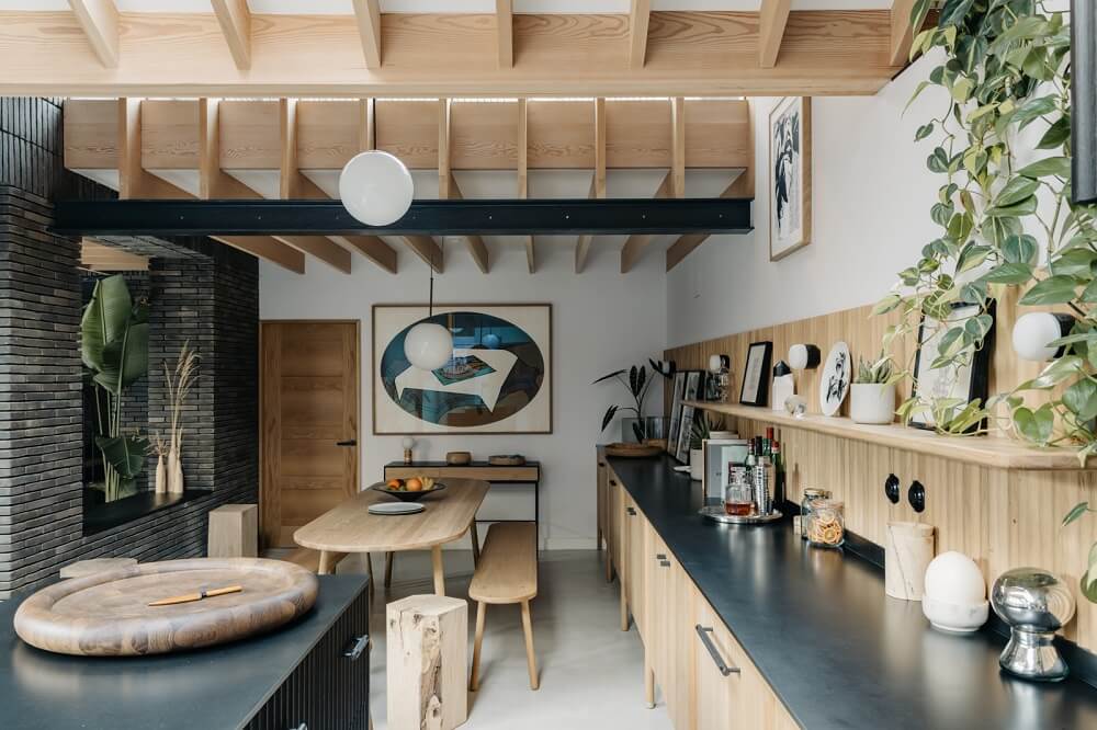 A Brick House in London Designed by Daniel Sanderson 11 black-wood-kitchen-rounded-kitchen-table-brick-house-nordroom