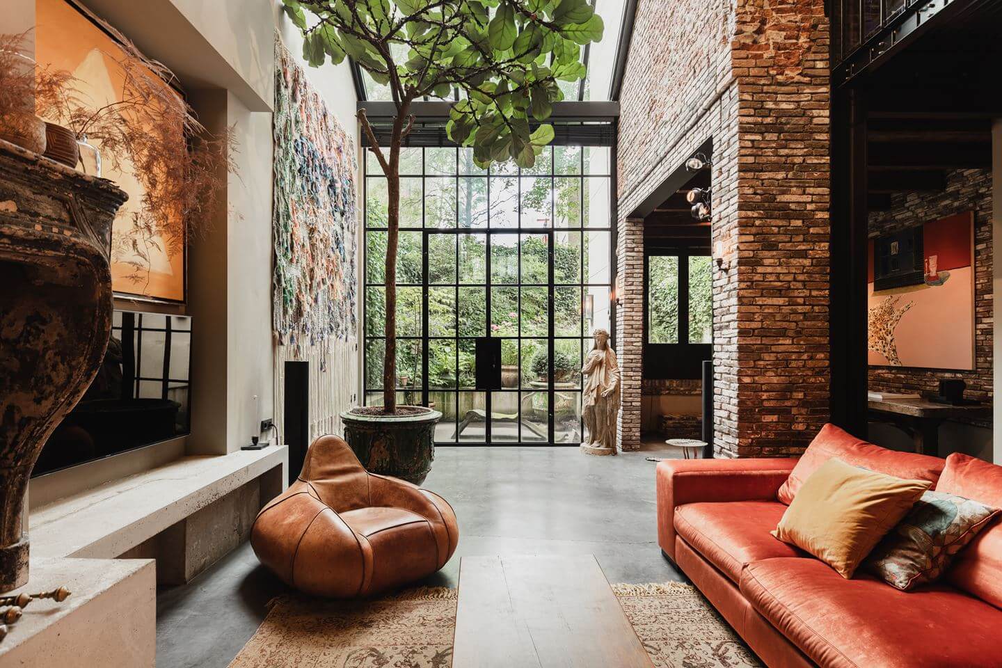 A Luxurious Townhouse in Amsterdam With Loft-Style Living Room 2 double-height-living-room-exposed-brick-industrial-glass-doors-nordroom