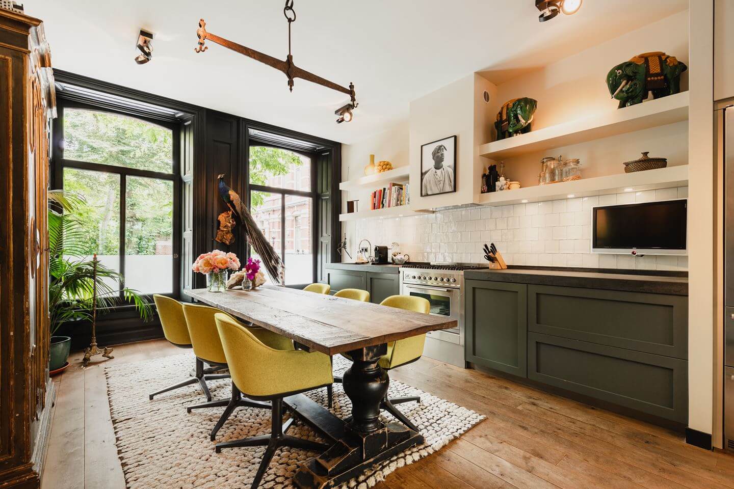 A Luxurious Townhouse in Amsterdam With Loft-Style Living Room 6 green-kitchen-open-shelves-dining-table-yellow-dining-chairs-townhouse-amsterdam-nordroom