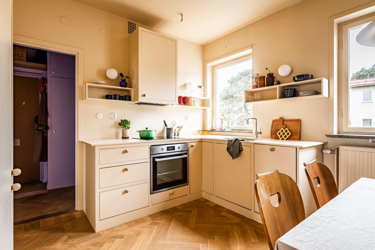 A Pink and Yellow Scandinavian Apartment 8 pale-yellow-kitchen-cabinets-walls-nordroom