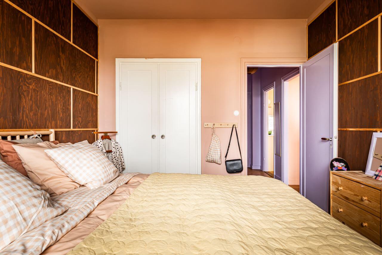 A Pink and Yellow Scandinavian Apartment 15 pink-bedroom-wood-accent-wall-nordroom
