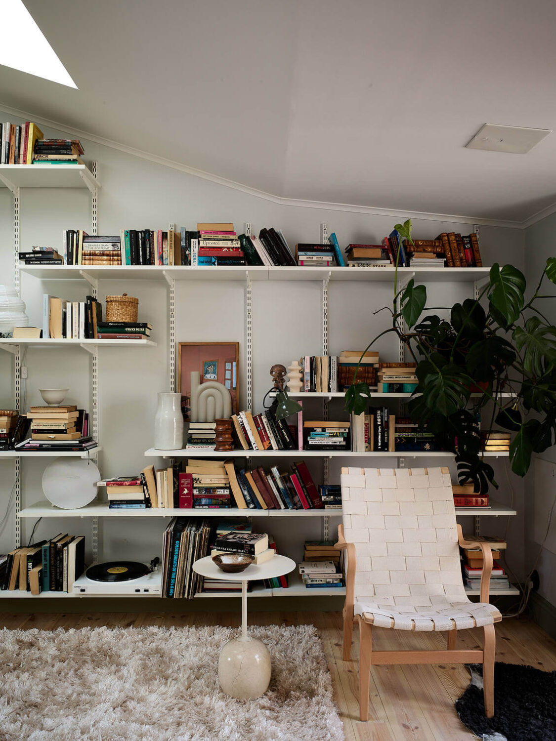 A Light Scandinavian Maisonette 6 sitting-room-slanted-ceiling-bookshelves-nordroom
