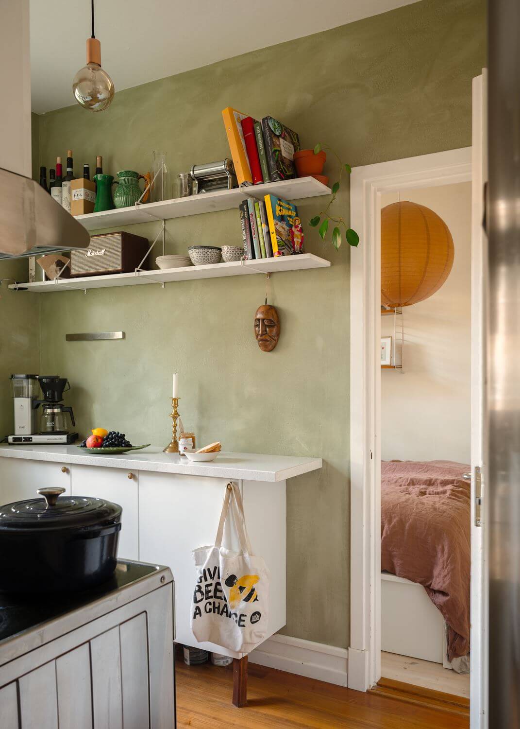 A Small Light Apartment with Plants 12 small-kitchen-green-walls-open-shelves-nordroom