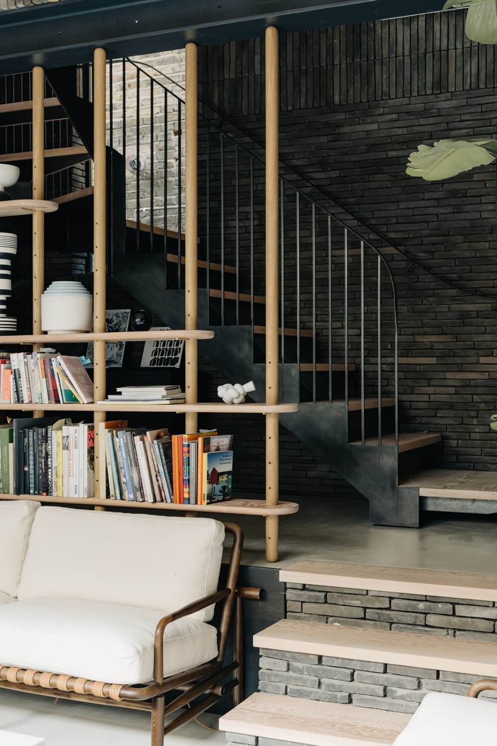 A Brick House in London Designed by Daniel Sanderson 2 sunken-living-room-black-brickwork-bookshelves-nordroom
