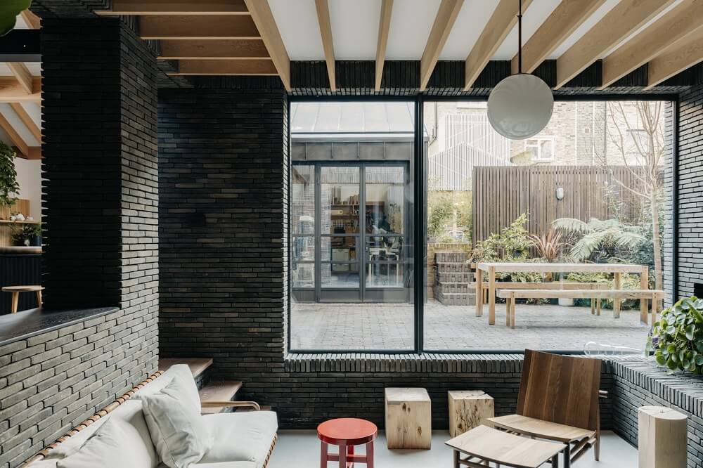 A Brick House in London Designed by Daniel Sanderson 5 sunken-living-room-large-window-courtyard-london-home-nordroom
