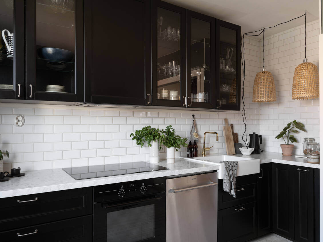 A Warm Neutral Colored Nordic Home 20 black-kitchen-cabinets-pendants-nordroom