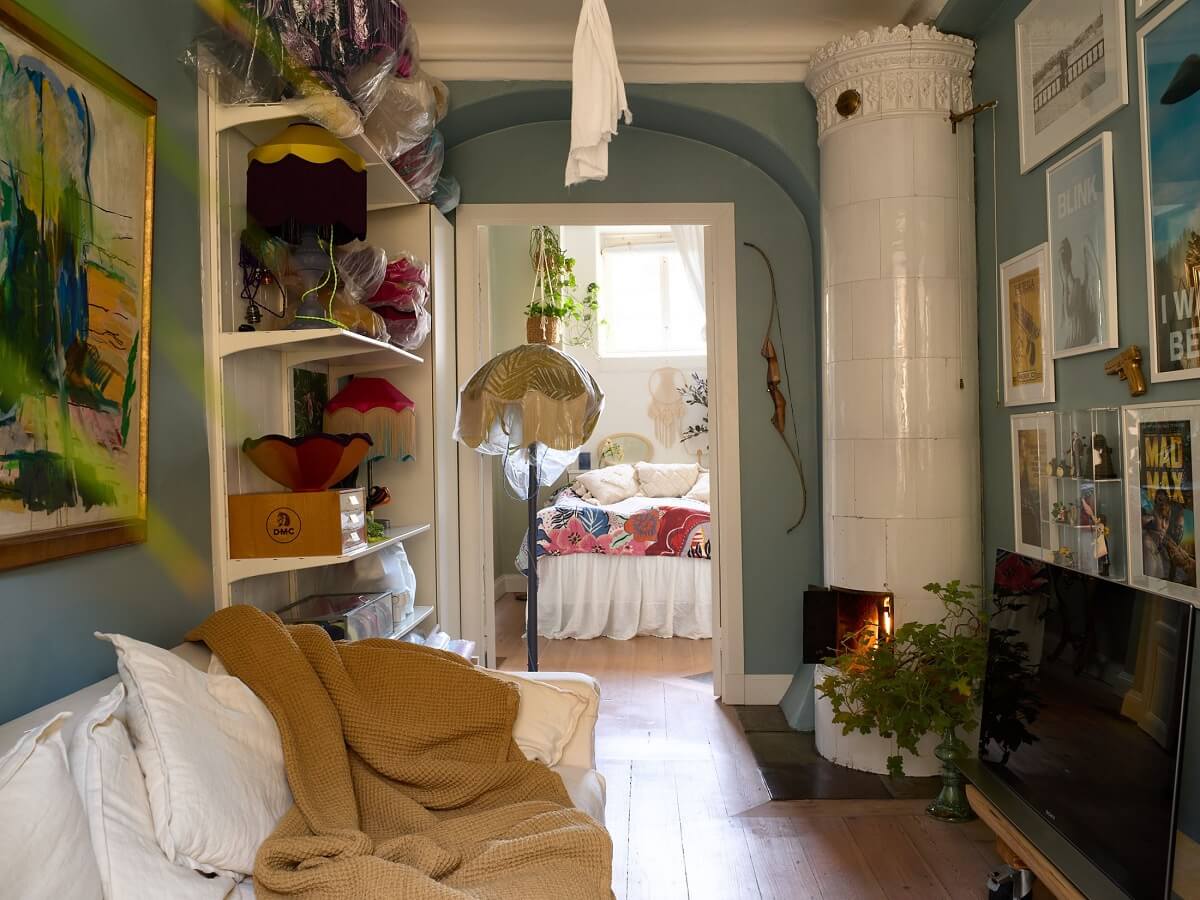 A Cozy Plant-Filled Home in Sweden 9 blue-sitting-room-kakelugn-swedish-fireplace-nordroom