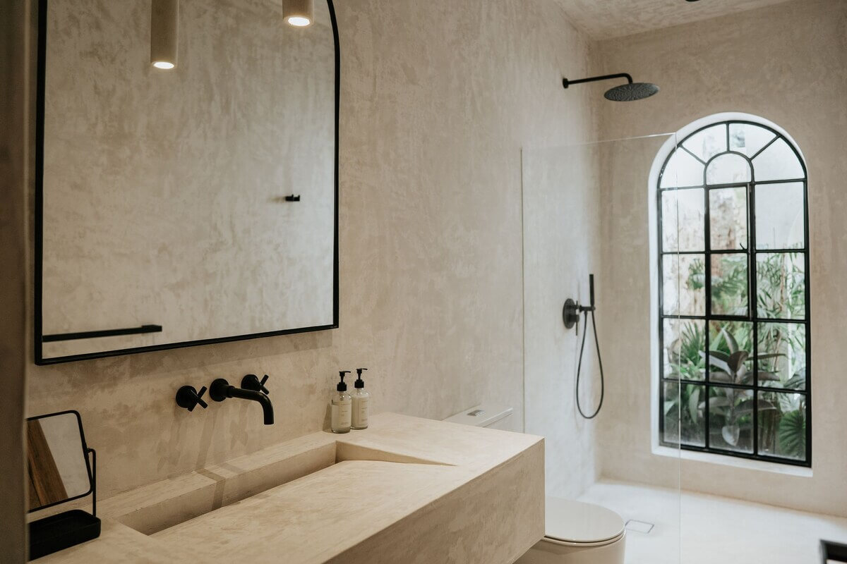 A Serene Loft Airbnb in Tulum, Mexico 21 minimalistic-bathroom-arched-window-airbnb-tulum-nordroom