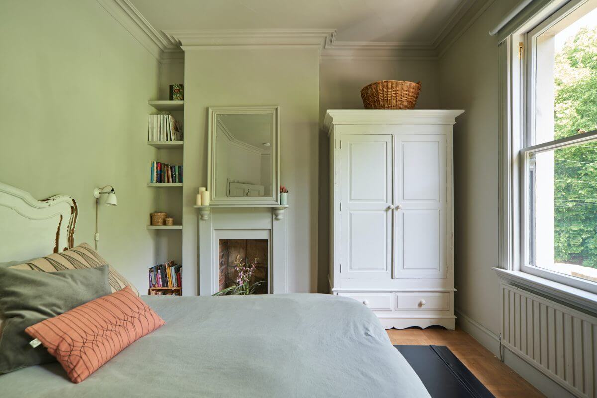A Mixture of Styles in an English Home 13 serene-bedroom-fireplace-built-in-bookshelves-nordroom