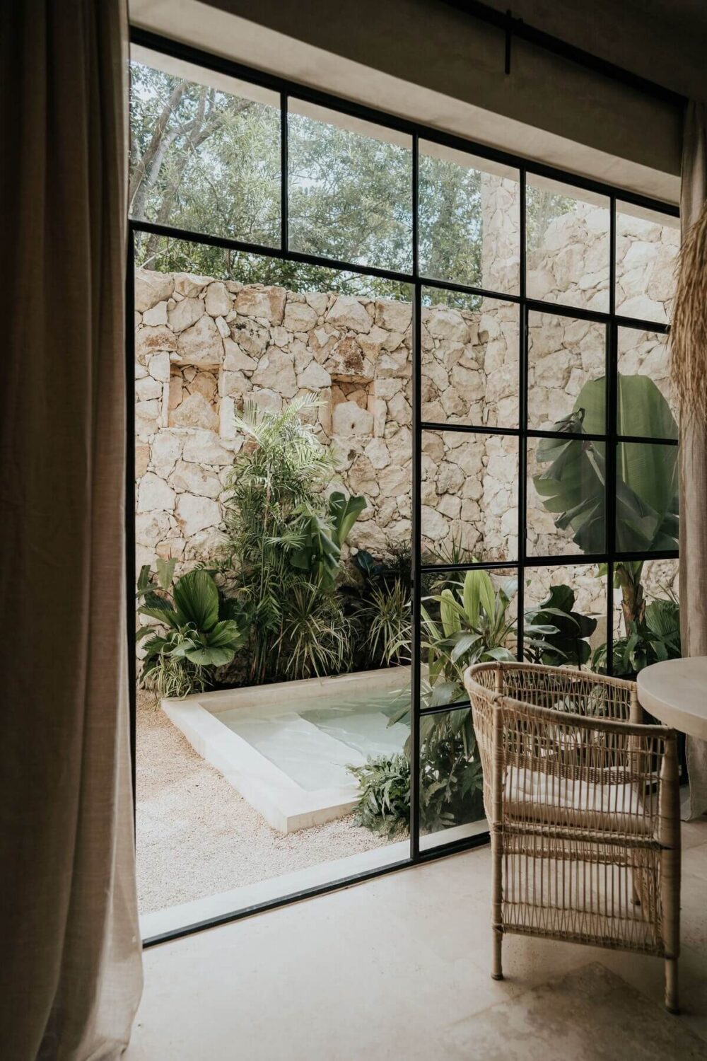 A Serene Loft Airbnb in Tulum, Mexico 7 steel-framed-glass-wall-outdoor-terrace-loft-airbnb-tulum-nordroom