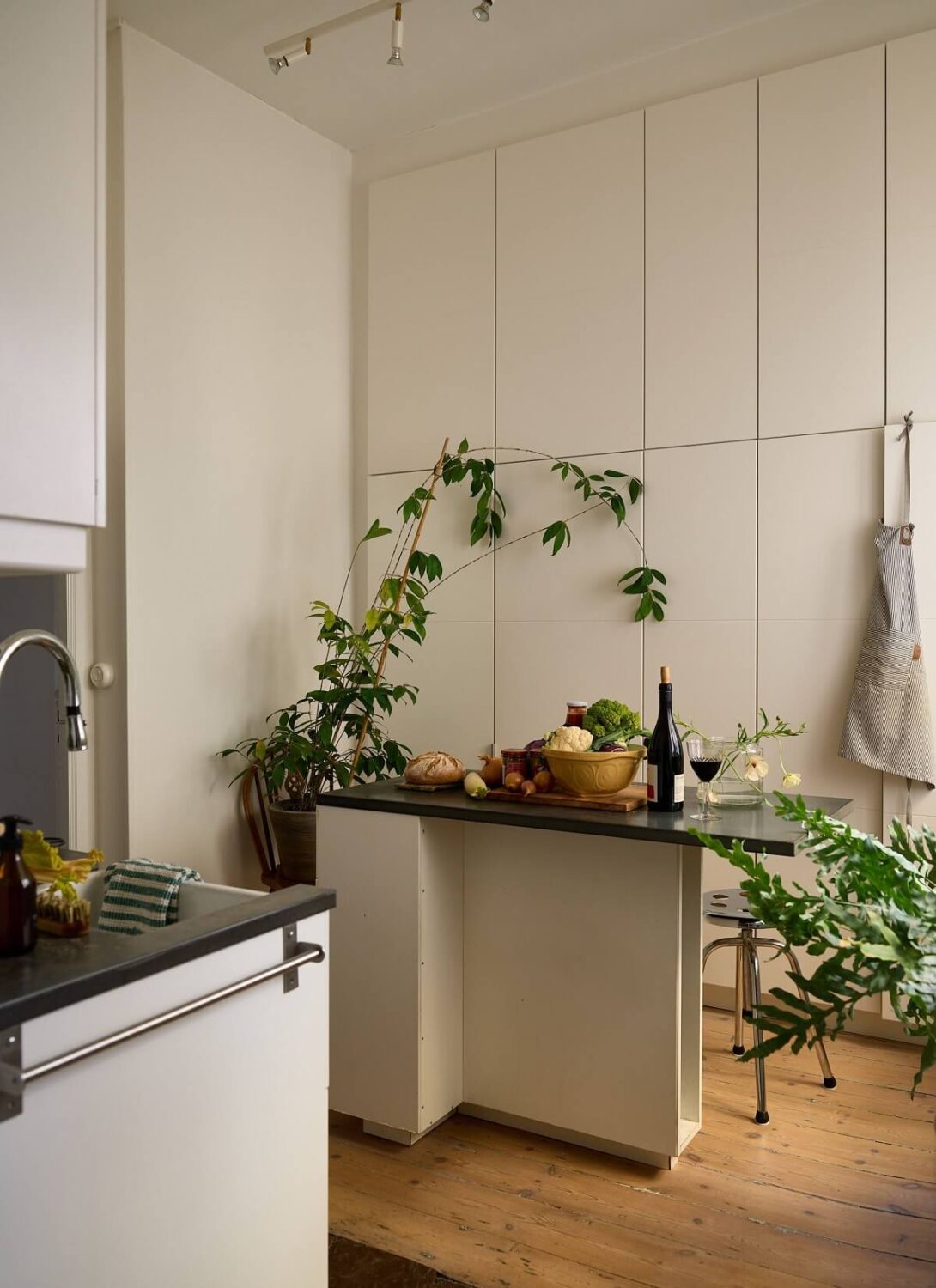 A Cozy Plant-Filled Home in Sweden 15 white-kitchen-floor-to-ceiling-cabinets-kitchen-island-nordroom