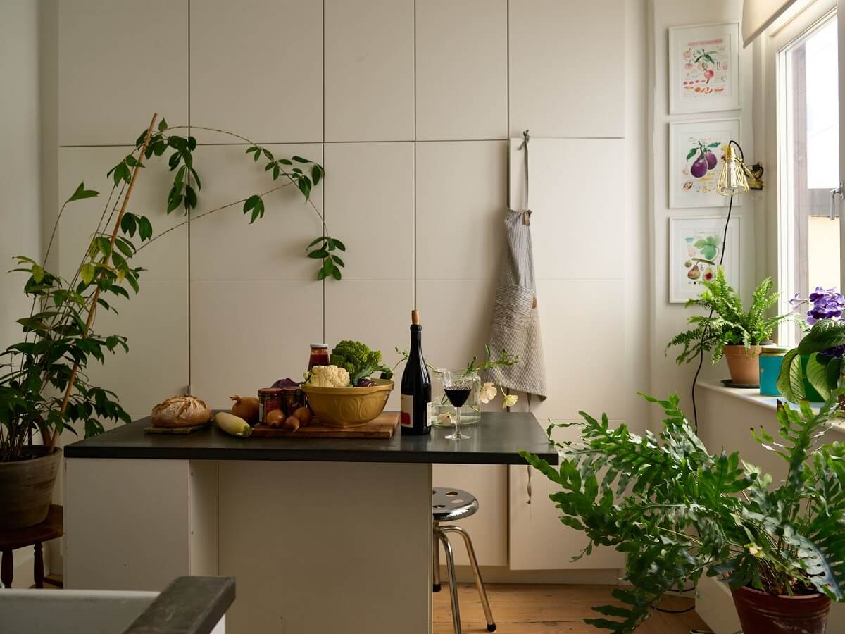 A Cozy Plant-Filled Home in Sweden 14 white-kitchen-sleek-cabinets-kitchen-island-nordroom